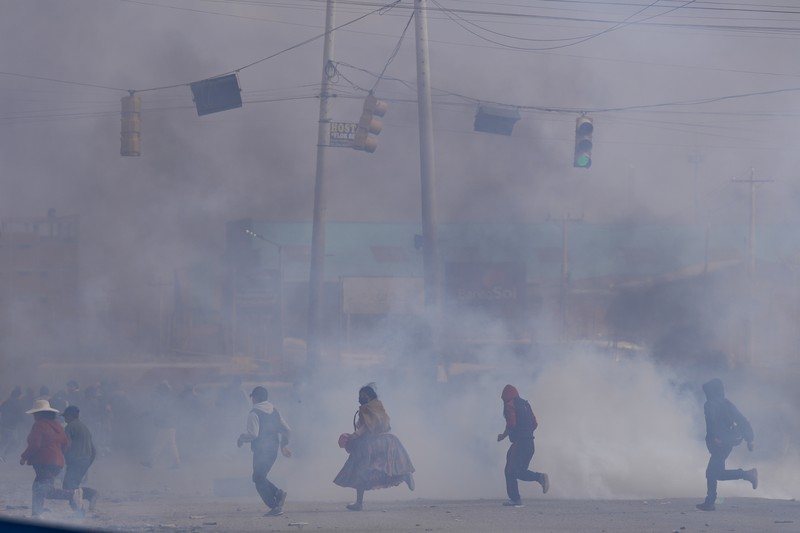 A supporter of former President Evo Morales clashes with supporters of current President Luis Arce in El Alto, Bolivia, Sunday, Sept. 22, 2024. (AP Photo/Juan Karita)