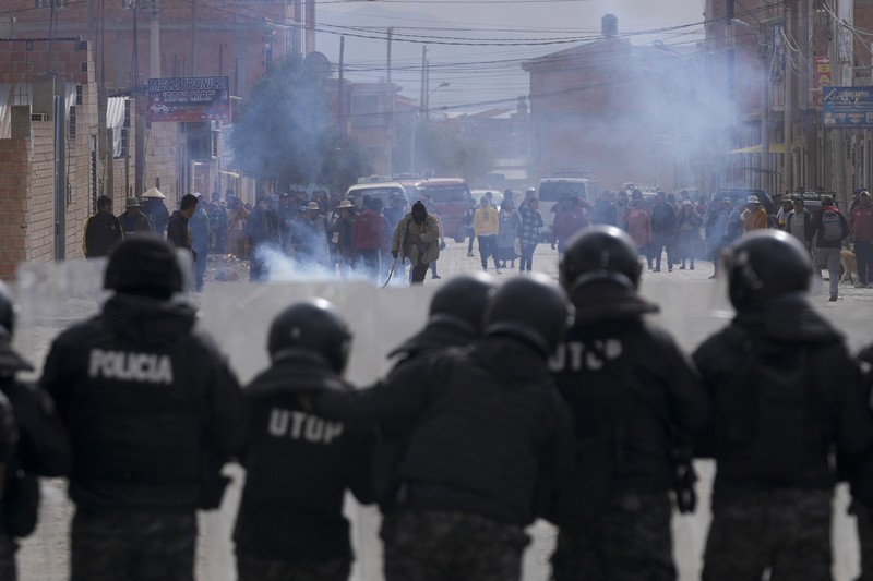 A supporter of former President Evo Morales clashes with supporters of current President Luis Arce in El Alto, Bolivia, Sunday, Sept. 22, 2024. (AP Photo/Juan Karita)