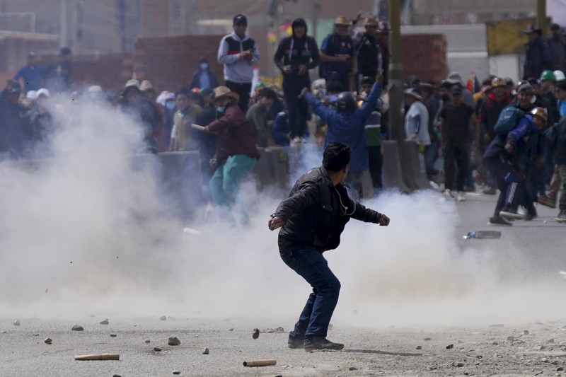 A supporter of former President Evo Morales clashes with supporters of current President Luis Arce in El Alto, Bolivia, Sunday, Sept. 22, 2024. (AP Photo/Juan Karita)