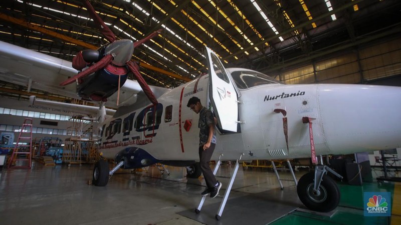 Petugas memeriksa pesawat N-219 Nurtanio yang berada di Hanggar PT Dirgantara Indonesia, Bandung, Jawa Barat, Jumat (27/9/2024). (CNBC Indonesia/Faisal Rahman)