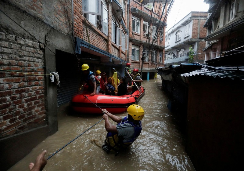 ASIA-WEATHER/NEPAL SENSITIVE MATERIAL. THIS IMAGE MAY OFFEND OR DISTURB Rescue personnel work to retrieve a body recovered from a debris of a passenger bus after a landslide triggered by heavy rainfall struck passenger vehicles passing by the Tribhuwan Highway in Dhading, Nepal, September 29, 2024. REUTERS/Navesh Chitrakar