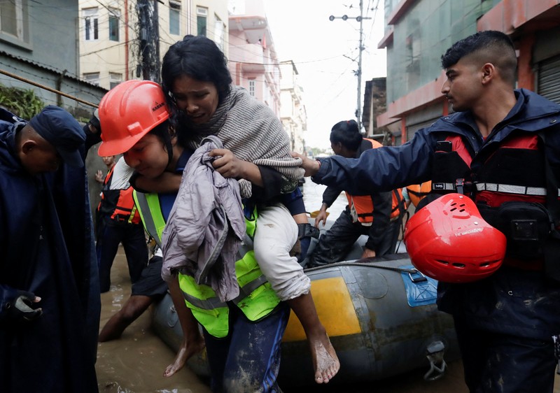 ASIA-WEATHER/NEPAL SENSITIVE MATERIAL. THIS IMAGE MAY OFFEND OR DISTURB Rescue personnel work to retrieve a body recovered from a debris of a passenger bus after a landslide triggered by heavy rainfall struck passenger vehicles passing by the Tribhuwan Highway in Dhading, Nepal, September 29, 2024. REUTERS/Navesh Chitrakar