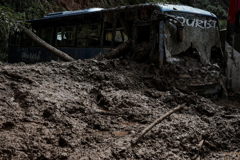 ASIA-WEATHER/NEPAL SENSITIVE MATERIAL. THIS IMAGE MAY OFFEND OR DISTURB Rescue personnel work to retrieve a body recovered from a debris of a passenger bus after a landslide triggered by heavy rainfall struck passenger vehicles passing by the Tribhuwan Highway in Dhading, Nepal, September 29, 2024. REUTERS/Navesh Chitrakar
