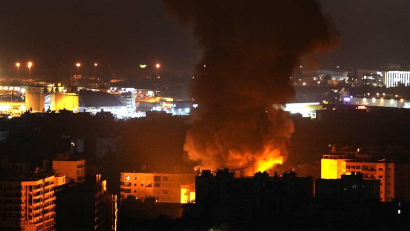 Flames and smoke rise from an Israeli airstrike in Dahiyeh, Beirut, Lebanon, early Sunday, Oct. 6, 2024. (AP Photo/Hussein Malla)