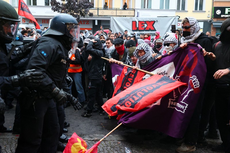 ISRAEL-PALESTINIANS/ANNIVERSARY GERMANY PROTEST A flare is thrown at police during a demonstration in support of Palestinians in Gaza, one day ahead of the anniversary of Hamas' October 7 attack on Israel, in Berlin, Germany, October 6, 2024. REUTERS/Christian Mang