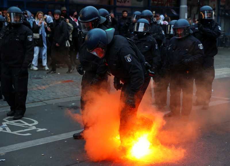 ISRAEL-PALESTINIANS/ANNIVERSARY GERMANY PROTEST A flare is thrown at police during a demonstration in support of Palestinians in Gaza, one day ahead of the anniversary of Hamas' October 7 attack on Israel, in Berlin, Germany, October 6, 2024. REUTERS/Christian Mang