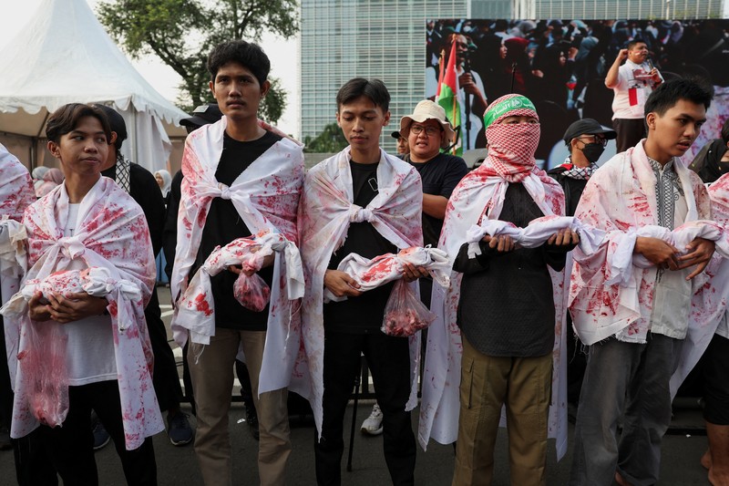 People raise Palestinian flags during a protest against Israel and in support of Palestinians outside the U.S. embassy in Jakarta, Indonesia, October 6, 2024. REUTERS/Ajeng Dinar Ulfiana