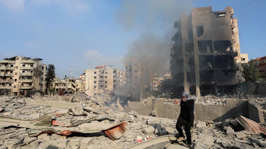 A woman walks on the rubble of a damaged site in the aftermath of Israeli strikes in Choueifat, amid the ongoing hostilities between Hezbollah and Israeli forces, Lebanon, October 6, 2024. REUTERS/Stringer     TPX IMAGES OF THE DAY