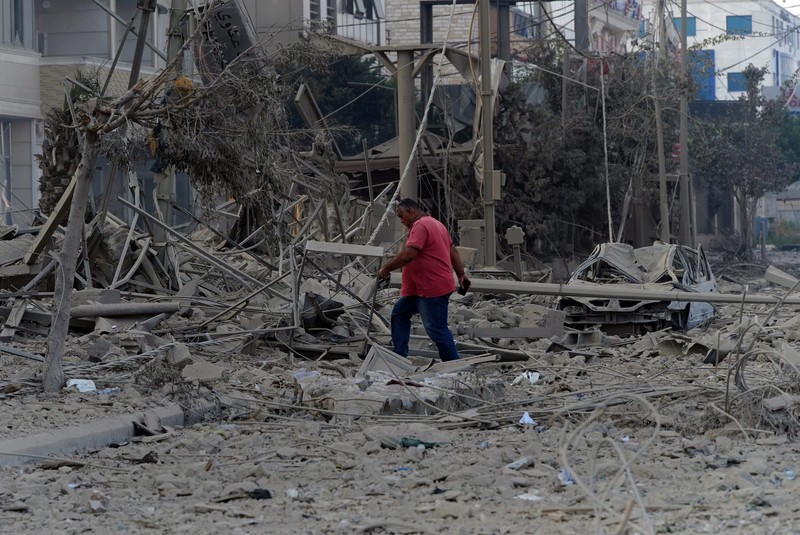 ISRAEL-PALESTINIANS/LEBANON A man walks on the rubble of a damaged site, in the aftermath of Israeli strikes on Beirut's southern suburbs, amid the ongoing hostilities between Hezbollah and Israeli forces, Lebanon, October 6, 2024. REUTERS/Stringer