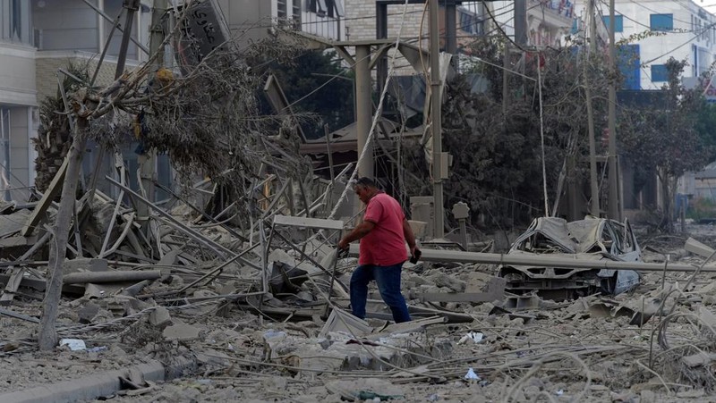 A man walks on the rubble of a damaged site, in the aftermath of Israeli strikes on Beirut's southern suburbs, amid the ongoing hostilities between Hezbollah and Israeli forces, Lebanon, October 6, 2024. REUTERS/Stringer