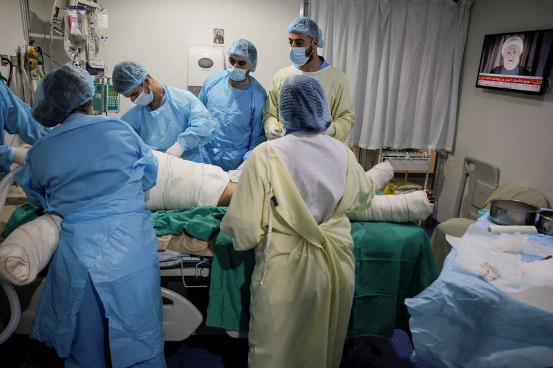 Medical staff members attend to a patient, casualty of an airstrike, in the ICU of Geitaoui Hospital burns unit, in Beirut, Lebanon, October 8, 2024. REUTERS/Louisa Gouliamaki
