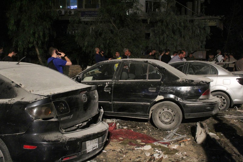 ISRAEL-PALESTINIANS/SYRIA Rescuers work at the site of an Israeli airstrike that targeted a residential building in the Mezzah suburb west of the Syrian capital Damascus, Syria's state news agency reported, Syria October 8, 2024. REUTERS/Firas Makdesi REFILE - QUALITY REPEAT