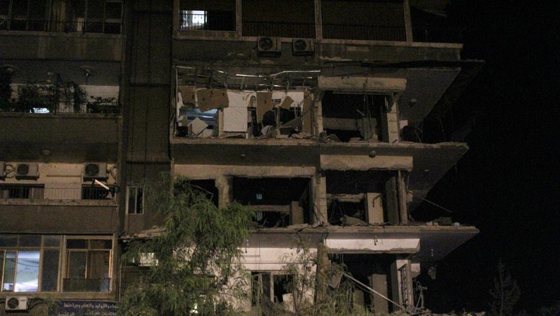 Rescuers work at the site of an Israeli airstrike that targeted a residential building in the Mezzah suburb west of the Syrian capital Damascus, Syria's state news agency reported, Syria October 8, 2024. REUTERS/Firas Makdesi REFILE - QUALITY REPEAT