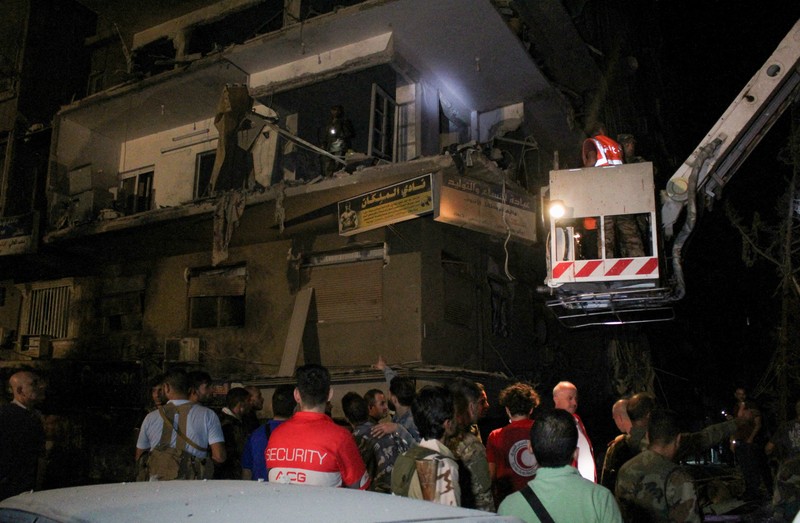 ISRAEL-PALESTINIANS/SYRIA Rescuers work at the site of an Israeli airstrike that targeted a residential building in the Mezzah suburb west of the Syrian capital Damascus, Syria's state news agency reported, Syria October 8, 2024. REUTERS/Firas Makdesi REFILE - QUALITY REPEAT