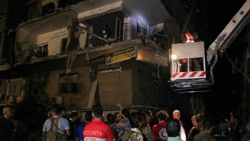 Rescuers work at the site of an Israeli airstrike that targeted a residential building in the Mezzah suburb west of the Syrian capital Damascus, Syria's state news agency reported, Syria October 8, 2024. REUTERS/Firas Makdesi REFILE - QUALITY REPEAT