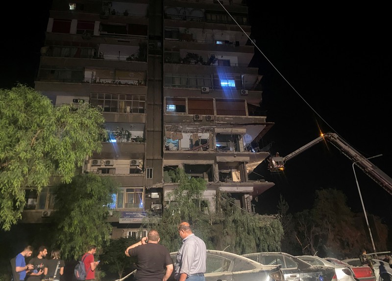 ISRAEL-PALESTINIANS/SYRIA Rescuers work at the site of an Israeli airstrike that targeted a residential building in the Mezzah suburb west of the Syrian capital Damascus, Syria's state news agency reported, Syria October 8, 2024. REUTERS/Firas Makdesi REFILE - QUALITY REPEAT