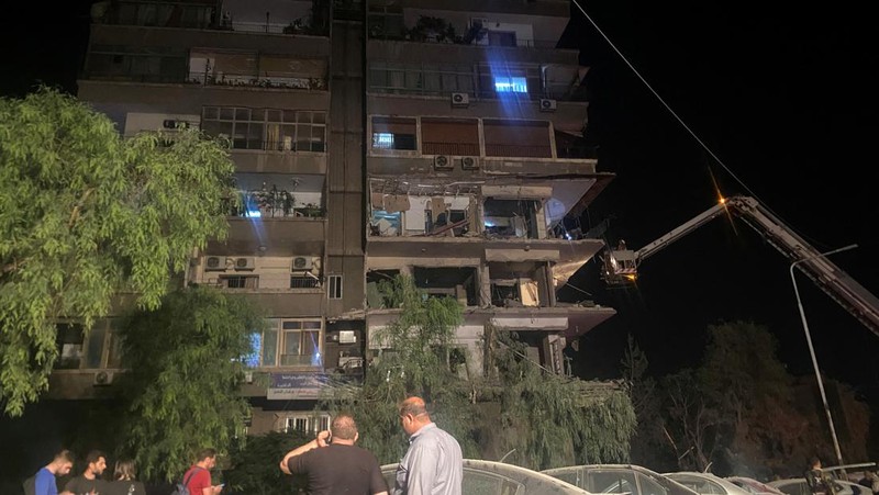Rescuers work at the site of an Israeli airstrike that targeted a residential building in the Mezzah suburb west of the Syrian capital Damascus, Syria's state news agency reported, Syria October 8, 2024. REUTERS/Firas Makdesi REFILE - QUALITY REPEAT