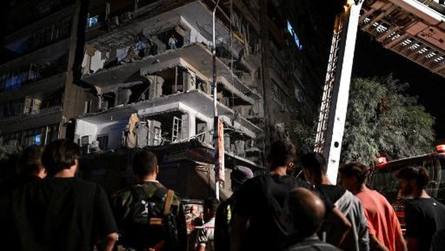 This picture shows a view of a residential building hit by a reported Israeli air strike, in the Mazzeh suburb on the western outskirts of Syria's capital Damascus on October 8, 2024. The Syrian defence ministry said seven people, including women and children, were killed in an Israeli air strike on a residential building in Damascus on October 8. (Photo by LOUAI BESHARA / AFP)