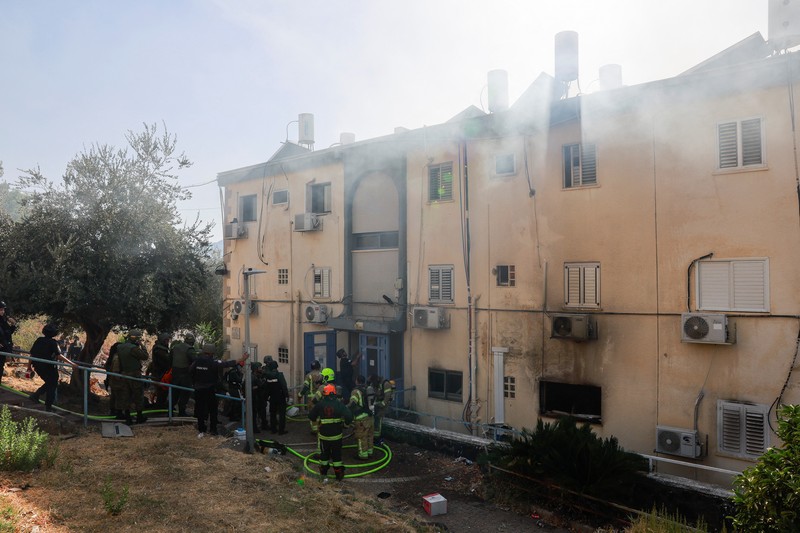 A man stands inside a residential apartment building that was damaged by a rocket fired from Lebanon, amid hostilities between Hezbollah and Israel, in Kiryat Yam, northern Israel, October 8, 2024. REUTERS/Shir Torem     TPX IMAGES OF THE DAY