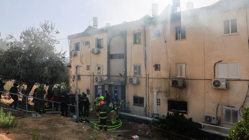 A man stands inside a residential apartment building that was damaged by a rocket fired from Lebanon, amid hostilities between Hezbollah and Israel, in Kiryat Yam, northern Israel, October 8, 2024. REUTERS/Shir Torem     TPX IMAGES OF THE DAY