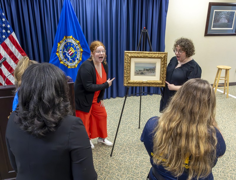 Francoise Parlagi, center, and Helen Lowe, far left, descendants of the original owners the Claude Monet painting entitled 