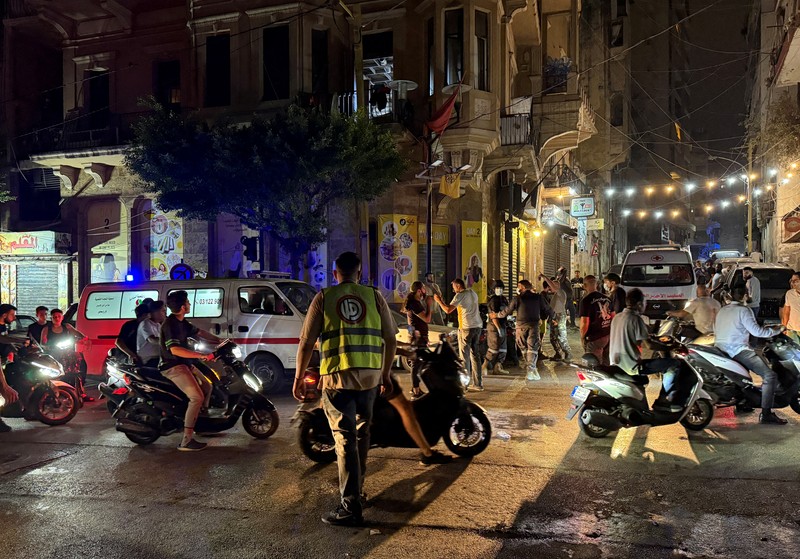 ISRAEL-PALESTINIANS/LEBANON-STRIKE-HEZBOLLAH A building stands on the street while smoke raises, after an Israeli air strike, amid ongoing hostilities between Hezbollah and Israeli forces, in Beirut, Lebanon, October 10, 2024. REUTERS/Louisa Gouliamaki