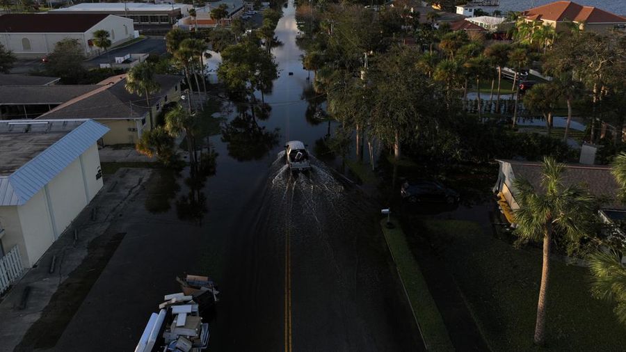 Pemandangan drone menunjukkan sebuah mobil melaju melalui jalan yang banjir setelah Badai Milton menerjang daratan di South Daytona, Florida, Amerika Serikat, Jumat (11/10/2024). (REUTERS/Ricardo Arduengo)