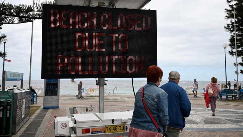 Kemunculan ratusan bola hitam misterius, yang menyerupai ter atau aspal, telah membuat dua pantai populer di area Sydney, Australia, ditutup sementara. (Saeed KHAN / AFP)