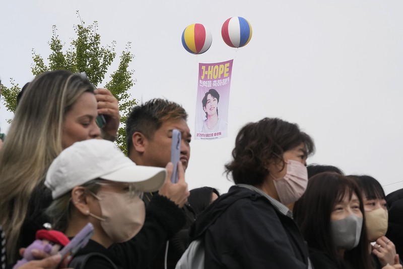 K-pop band BTS's member J-Hope reacts after being discharged from a mandatory military service outside of an army base in Wonju, South Korea, Thursday, Oct. 17, 2024. (AP Photo/Ahn Young-joon)