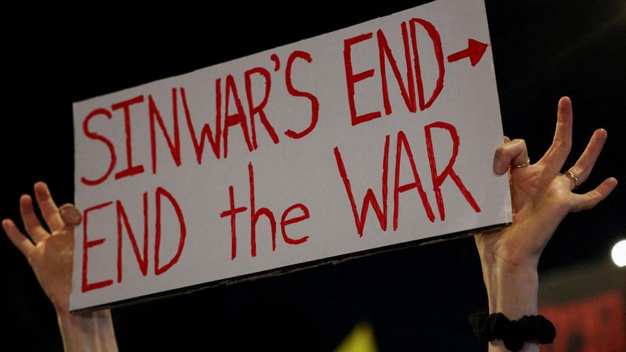 A person holds a sign with a reference to Hamas leader Yahya Sinwar, after Israeli military said they have killed him, as families and supporters of hostages kidnapped during the deadly October 7, 2023 attack, protest to demand their immediate release, amid the ongoing conflict in Gaza between Israel and Hamas, in Tel Aviv, Israel, October 17, 2024. REUTERS/Violeta Santos Moura
