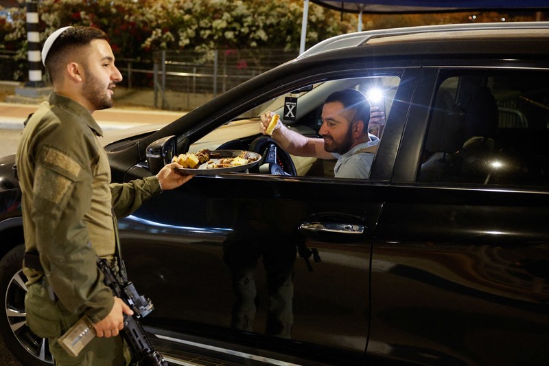 People react after Israeli military said they have killed Hamas leader Yahya Sinwar, in Sderot, Israel, October 17, 2024. REUTERS/Amir Cohen