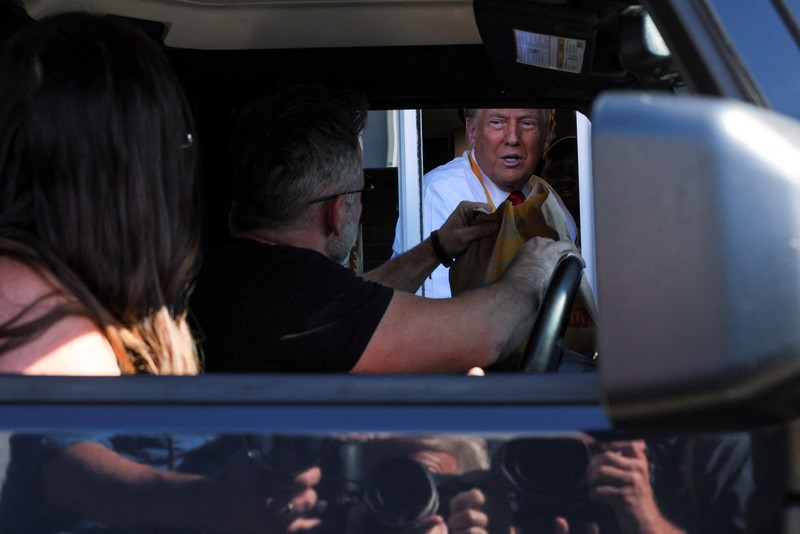 Calon presiden dari Partai Republik dan mantan Presiden AS Donald Trump bekerja di belakang meja saat berkunjung ke McDonald's di Feasterville-Trevose, Pennsylvania, AS, 20 Oktober 2024. (Doug Mills/Pool via REUTERS)