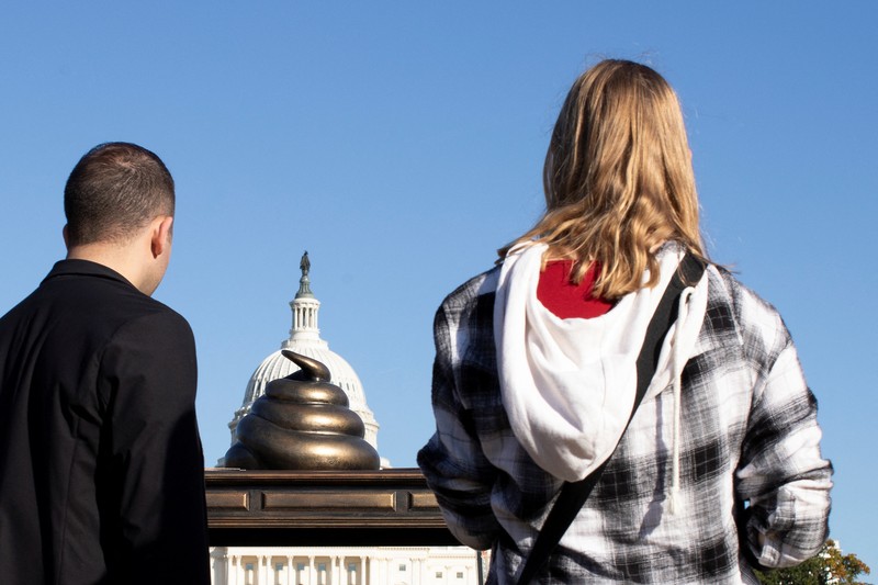 USA-CAPITOL/POOP A new temporary statue of a brass-colored desk with a large poop-shaped emoji on top of it, referencing those who attacked the U.S. Capitol on January 6, 2021, is seen near the Capitol in Washington, U.S., October 25, 2024. REUTERS/Kaylee Greenlee Beal