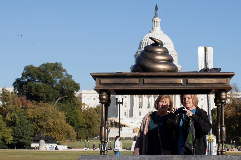 USA-CAPITOL/POOP A new temporary statue of a brass-colored desk with a large poop-shaped emoji on top of it, referencing those who attacked the U.S. Capitol on January 6, 2021, is seen near the Capitol in Washington, U.S., October 25, 2024. REUTERS/Kaylee Greenlee Beal
