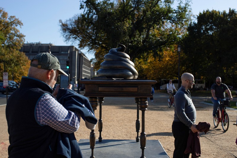 USA-CAPITOL/POOP A new temporary statue of a brass-colored desk with a large poop-shaped emoji on top of it, referencing those who attacked the U.S. Capitol on January 6, 2021, is seen near the Capitol in Washington, U.S., October 25, 2024. REUTERS/Kaylee Greenlee Beal