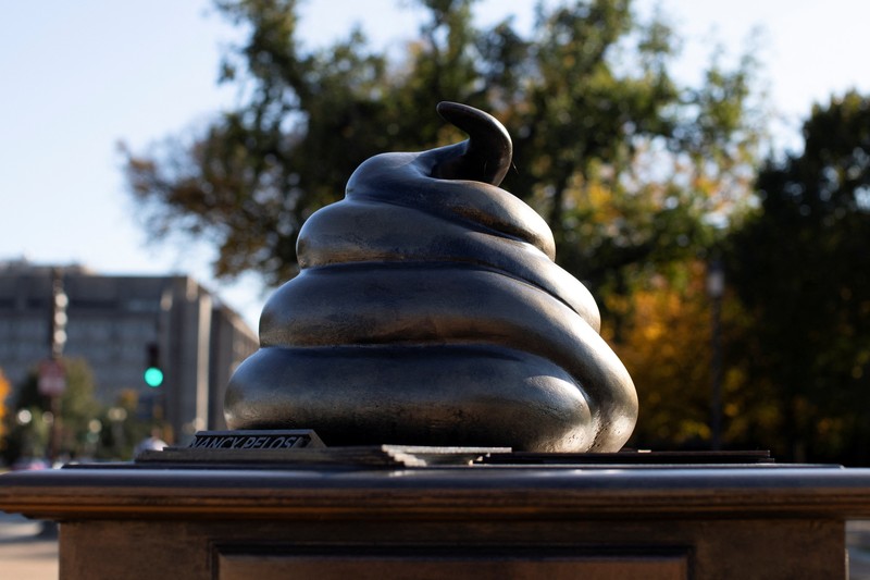 USA-CAPITOL/POOP A new temporary statue of a brass-colored desk with a large poop-shaped emoji on top of it, referencing those who attacked the U.S. Capitol on January 6, 2021, is seen near the Capitol in Washington, U.S., October 25, 2024. REUTERS/Kaylee Greenlee Beal