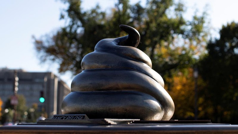 A new temporary statue of a brass-colored desk with a large poop-shaped emoji on top of it, referencing those who attacked the U.S. Capitol on January 6, 2021, is seen near the Capitol in Washington, U.S., October 25, 2024. REUTERS/Kaylee Greenlee Beal