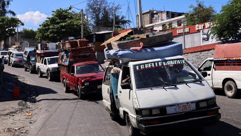 Seorang pria membawa sofa saat melarikan diri dari rumahnya dari kekerasan geng, di Port-au-Prince, Haiti, 26 Oktober 2024. 
 (REUTERS/Ralph Tedy Erol)