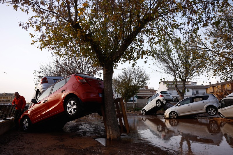 EUROPE-WEATHER/SPAIN-STORM Residents stand outside their homes next to damaged belongings after floods in Utiel, Spain, October 30, 2024. REUTERS/Susana Vera