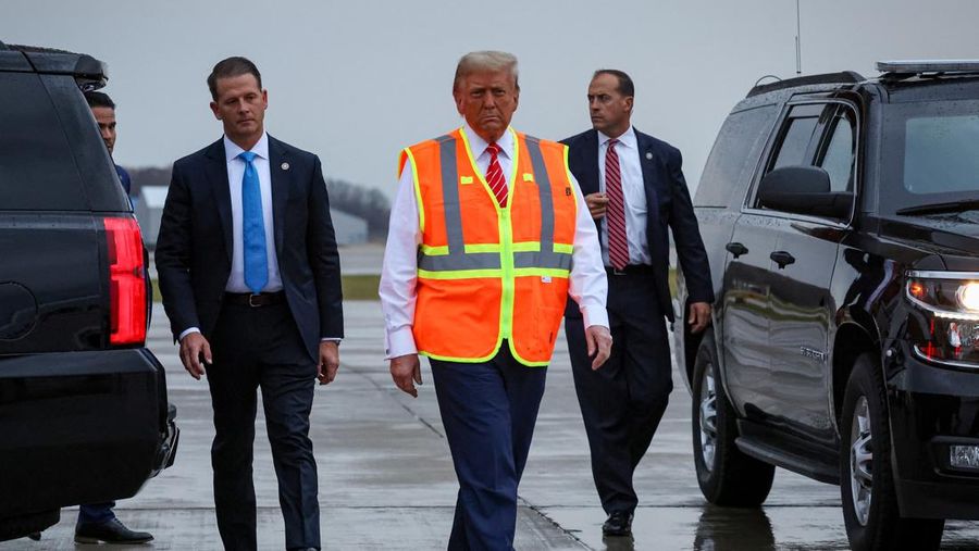 Republican presidential nominee and former U.S. President Donald Trump sits inside garbage truck as he wears a high-vis vest, on tarmac at Green Bay Austin Straubel International Airport in Green Bay, Wisconsin, U.S., October 30, 2024. REUTERS/Brendan McDermid