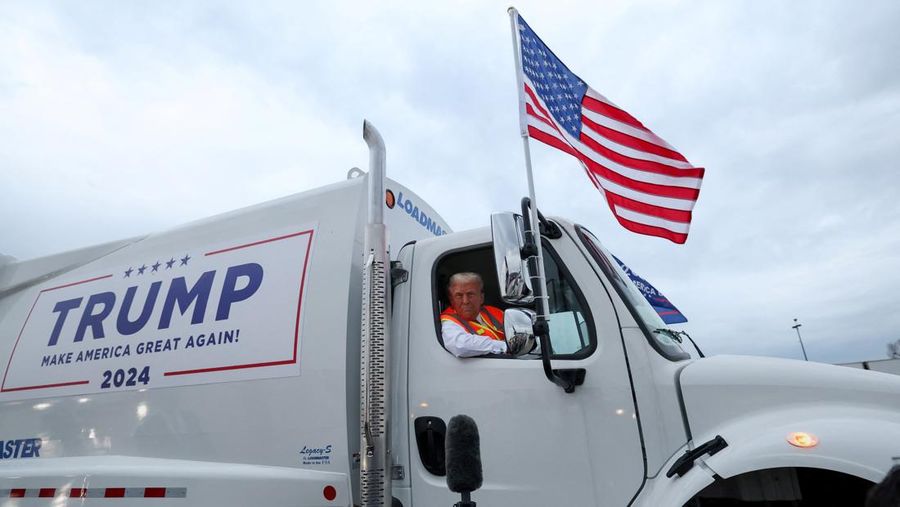 Republican presidential nominee and former U.S. President Donald Trump sits inside garbage truck as he wears a high-vis vest, on tarmac at Green Bay Austin Straubel International Airport in Green Bay, Wisconsin, U.S., October 30, 2024. REUTERS/Brendan McDermid