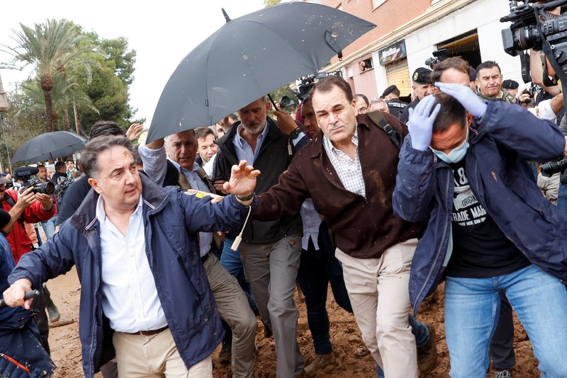 Seorang pria bereaksi di samping Ratu Spanyol Letizia, setelah hujan lebat yang menyebabkan banjir, di Paiporta, dekat Valencia, Spanyol, 3 November 2024. (REUTERS/Eva Manez)