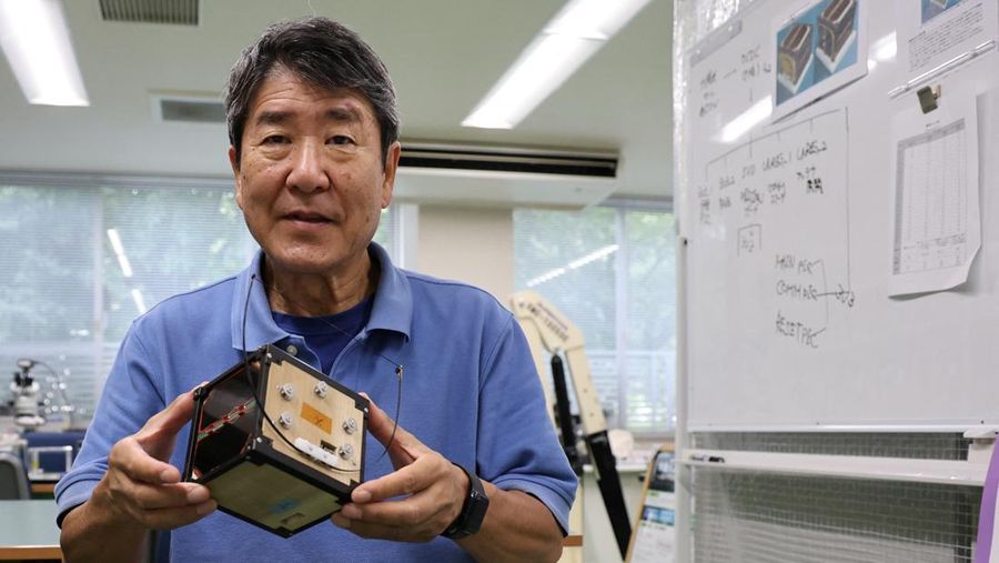 Takao Doi, a former Japanese astronaut and professor at Kyoto University, holds an engineering model of LignoSat during an interview with Reuters at his laboratory at Kyoto University in Kyoto, Japan, October 25, 2024. REUTERS/Irene Wang