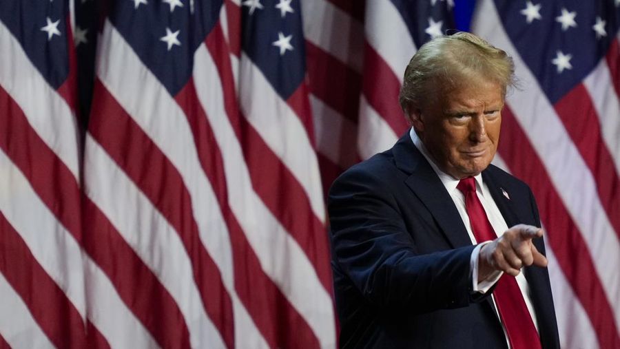 Republican presidential nominee former President Donald Trump points to the crowd at an election night watch party, Wednesday, Nov. 6, 2024, in West Palm Beach, Fla. (AP Photo/Julia Demaree Nikhinson)