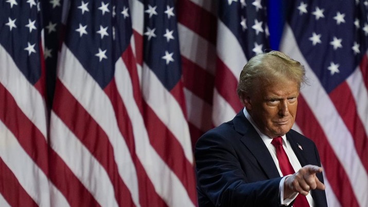 Republican presidential nominee former President Donald Trump points to the crowd at an election night watch party, Wednesday, Nov. 6, 2024, in West Palm Beach, Fla. (AP Photo/Julia Demaree Nikhinson)