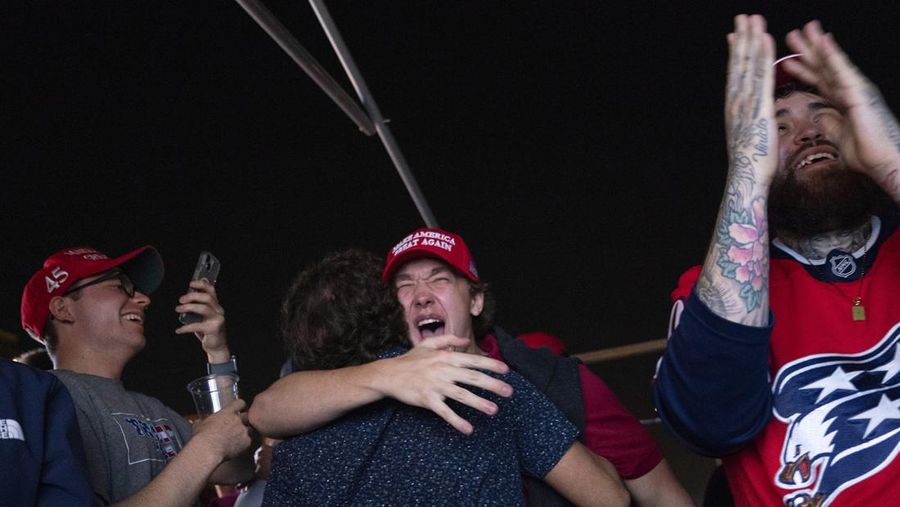 Supporters of Republican presidential nominee former President Donald Trump react to news that Trump won the state of Georgia during a watch party in Washington, Wednesday, Nov. 6, 2024. (AP Photo/Nathan Howard)