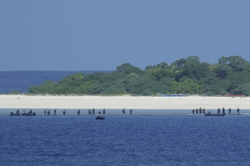 Philippine Navy Fast Attack Interdiction Craft Lolinato To-Ong passes by a Chinese Navy ship during a Philippine military multi-service joint exercise on Wednesday Nov. 6, 2024 at Loaita island locally called Kota island at the disputed South China Sea, Philippines. (AP Photo/Aaron Favila)