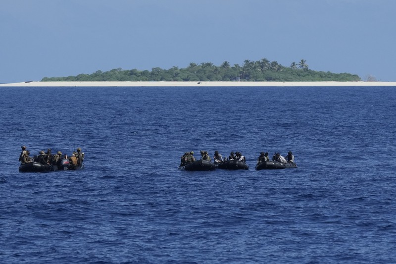 Philippine Navy Fast Attack Interdiction Craft Lolinato To-Ong passes by a Chinese Navy ship during a Philippine military multi-service joint exercise on Wednesday Nov. 6, 2024 at Loaita island locally called Kota island at the disputed South China Sea, Philippines. (AP Photo/Aaron Favila)
