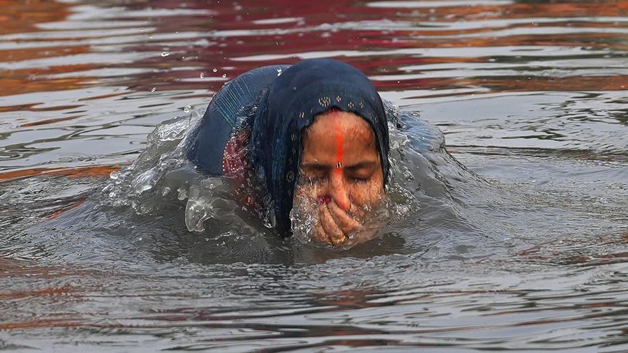 Festival keagamaan Hindu Chhath Puja tetap berlangsung khidmat meski buih-buih limbah menutupi Sungai Yamuna, New Delhi, India, Kamis (7/11). (REUTERS/Anushree Fadnavis)