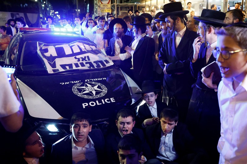 Kaum Yahudi ultra-Ortodoks Israel berunjuk rasa setelah militer Israel mengeluarkan pemberitahuan panggilan kepada lebih banyak anggota komunitas mereka untuk memperkuat pasukannya, di tengah konflik yang sedang berlangsung di Gaza antara Israel dan Hamas serta permusuhan lintas perbatasan dengan Hizbullah di Lebanon, di Bnei Brak, Israel, 17 November 2024. Kaum Yahudi ultra-Ortodoks Israel berunjuk rasa setelah militer Israel mengeluarkan pemberitahuan panggilan kepada lebih banyak anggota komunitas mereka untuk memperkuat pasukannya, di tengah konflik yang sedang berlangsung di Gaza antara Israel dan Hamas serta permusuhan lintas perbatasan dengan Hizbullah di Lebanon, di Bnei Brak, Israel, 17 November 2024. (REUTERS/Thomas Peter)